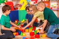 Break school of children playing in kids cubes indoor.