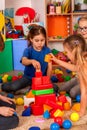 Break school of children playing in kids cubes indoor.