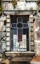 Break stained glass window  formed a cross with metal grid and moss in the facade Royalty Free Stock Photo