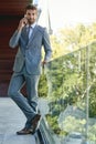 Break time catch up with a client. Portrait of a young businessman talking on his phone while standing on an office Royalty Free Stock Photo