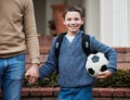 Break time is going to be fun. a little boy ready to go to school holding a soccer ball. Royalty Free Stock Photo