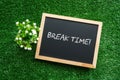 BREAK TIME! text in white chalk handwriting on a blackboard Royalty Free Stock Photo