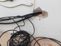 Break in the wall with protruding electrical wires, Electric wire sticking out of a white wall