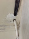 Break in the wall with protruding electrical wires, Electric wire sticking out of a white wall