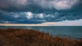 Breakage of the shore by the sea before the storm. Dramatic clouds