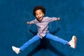 Breakdancing joyful african american cute little child boy levitating in jump. Royalty Free Stock Photo