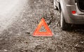 Breakdown of car. Red warning triangle sign on road Royalty Free Stock Photo