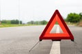 Breakdown triangle stands alongside the road. Broken car sign on a road concept