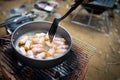 Breakfast for all ages,Pigs in Blankets or Mini sausages wrapped in smoked bacon on a hot frying pan on a charcoal grill at Royalty Free Stock Photo