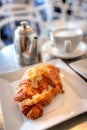 Breakfast almond croissant puff pastry with cup of tea latte
