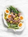 Breakfast, appetizers salads - boiled eggs, potatoes, string beans, red onion, cucumber, canned tuna salad on a light background, Royalty Free Stock Photo