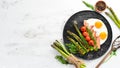 Breakfast. Asparagus, eggs, bacon and cherry tomatoes. Healthy food. Top view. Royalty Free Stock Photo