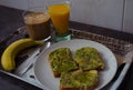 Breakfast with avocado on toast with a banana, coffee, and juice