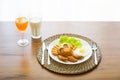 Breakfast with bacon, fried egg, fried chicken, orange juice and Royalty Free Stock Photo