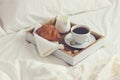 Breakfast in bad, tray with cup of coffee and croissant Royalty Free Stock Photo