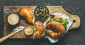 Breakfast with bagel, espresso coffee and capers in blue bowl