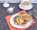 Breakfast, bagel with scramble egg, ham, arugula and vegetables on a white plate Royalty Free Stock Photo