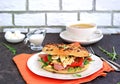 Breakfast, bagel with scramble egg, ham, arugula and vegetables on a white plate Royalty Free Stock Photo