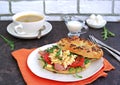 Breakfast, bagel with scramble egg, ham, arugula and vegetables on a white plate Royalty Free Stock Photo