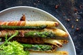 Breakfast of baked asparagus in spices with bacon, poached egg and crispy salad. Royalty Free Stock Photo