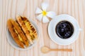 Breakfast with Baker Vietnamese or Viet Nam bread and black coffee with white plumeria flower on wooden retro background, top vi Royalty Free Stock Photo