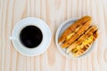 Breakfast with Baker Vietnamese or Viet Nam bread and black coffee on wooden retro background, top view. Royalty Free Stock Photo