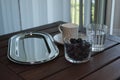 Breakfast at the balcony with a cup of fresh coffee, blueberries and rose on the wooden table