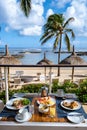 breakfast at a beach with palm trees and pool in Mauritius, tropical setting with breakfast Royalty Free Stock Photo