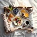 Breakfast in bed. Coffee, fruit and croissants on the bed