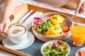 Breakfast in Bed with Coffee, Orange Juice, Salad, Fruits and Eggs Benedict Royalty Free Stock Photo