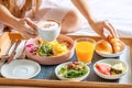 Breakfast in Bed with Coffee, Orange Juice, Salad, Fruits and Eggs Benedict Royalty Free Stock Photo