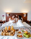 Breakfast in bed, couple drinking coffee in bed in the morning at an luxury hotel room Royalty Free Stock Photo