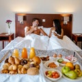 Breakfast in bed, couple drinking coffee in bed in the morning at an luxury hotel room Royalty Free Stock Photo