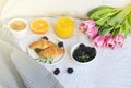 Breakfast in bed, croissant, coffee cup, berries, orange juice, Royalty Free Stock Photo