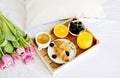 Breakfast in bed, croissant, coffee cup, berries, orange juice, Royalty Free Stock Photo