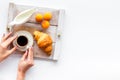 Breakfast in bed with croissant, coffee in cup with milk on tray on white background top view Royalty Free Stock Photo