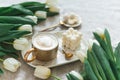 Breakfast in bed, cup of cappuccino, flowers