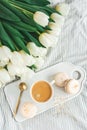 Breakfast in bed, cup of cappuccino, flowers