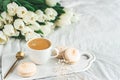 Breakfast in bed, cup of cappuccino, flowers