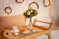 Breakfast in bed, flowers, tea and buns, beautiful food, candles. Dinner in the bedroom. New Year`s sides, lights. Christmas