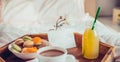 Breakfast in bed with i love you text on a note. Cup of coffee, juice, macaroons, rose flower on wooden tray. Romantic breakfast Royalty Free Stock Photo