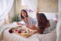 Breakfast in bed. Lesbian couple having breakfast in bed Royalty Free Stock Photo