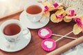 Breakfast in bed in Valentines day. Cup of tea and sweet candies. Love or holiday concept Royalty Free Stock Photo
