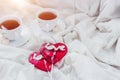 Breakfast in bed in Valentines day. Cup of tea and sweet candies. Love or holiday concept