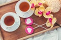 Breakfast in bed in Valentines day. Cup of tea and sweet candies. Love or holiday concept Royalty Free Stock Photo