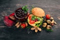 Breakfast. Beetroot juice and avocado burger and vegetables. On a wooden background.