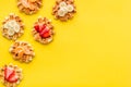 Breakfast with Belgian waffles with strawberry, tangerine and banana topings on yellow background top view mock up