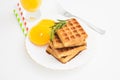 Breakfast with belgium waffles with rosemary and orange slices. Closeup view Royalty Free Stock Photo