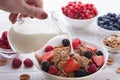 Breakfast - berries, fruit and muesli on white wooden Royalty Free Stock Photo