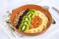 Breakfast berry smoothie bowl topped with bananas, berries, kiwi, almonds and sunflower seeds. Royalty Free Stock Photo